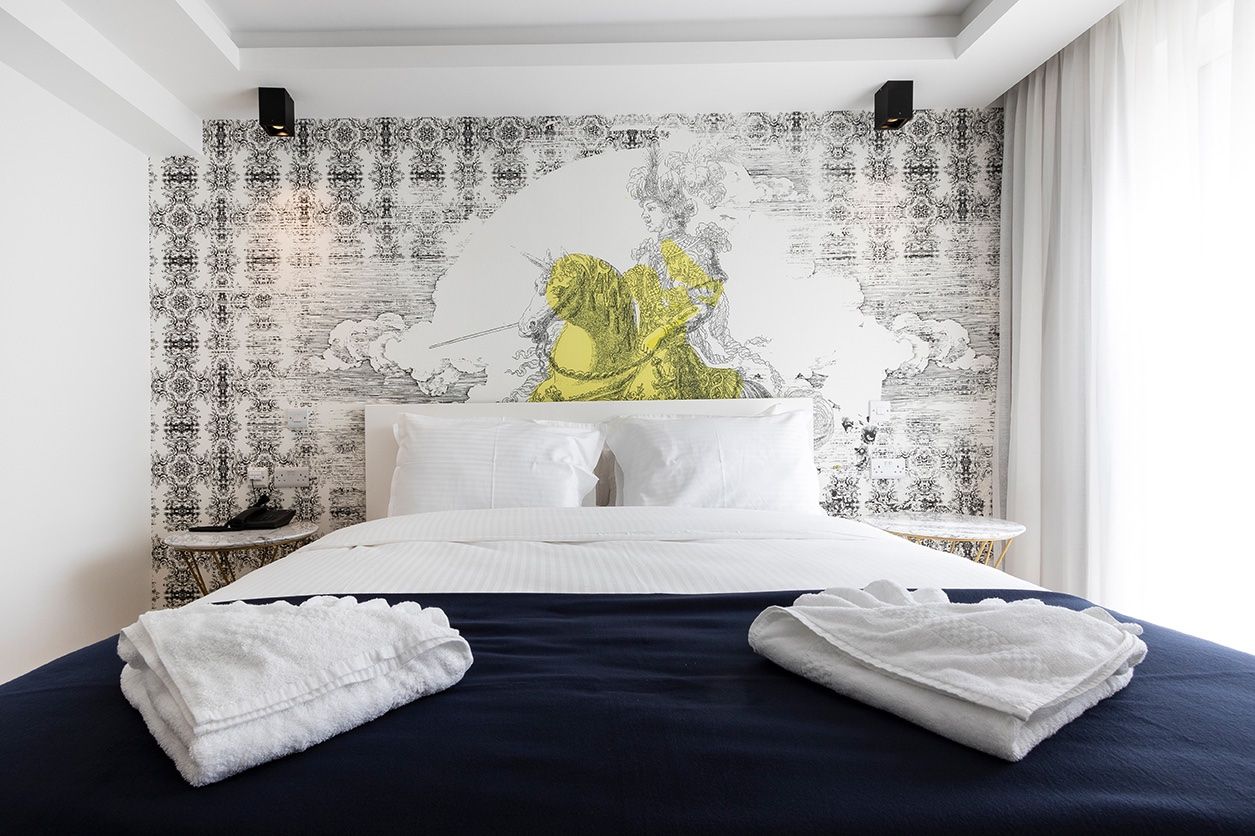 A made-up hotel bed with folded towels